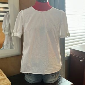 White shirt with buckles on arms. Size PS.